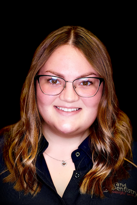 Natalie C., front office team member at Grand Dentistry in Escondido, CA, wearing a blue polo